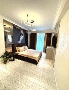 een slaapkamer met een bed en een televisie. bij Luxury City-Centric Apartment for Booking in Chişinău