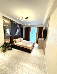 a bedroom with a bed and a television in it at Luxury City-Centric Apartment for Booking in Chişinău