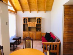 a living room with a couch and a table at Cabaña de Campo tulahuen in Piedra Lisa +6 photos
