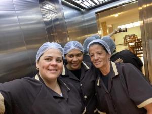 a group of three women standing next to each other at Simar Hotel in Araranguá