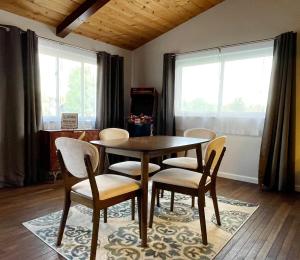 a dining room with a wooden table and chairs at Fishing bungalow on the water w/private dock in Clearlake