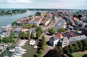 an aerial view of a city with boats in the water at Postillion Hotel Dordrecht in Dordrecht