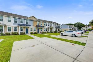 a row of houses with cars parked in the driveway at Daisy Place in Charleston