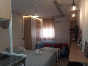 サン・ファン・デ・アスナルファラチェにあるEL RINCON DE SEVILLA a 9 min. del centro en Metroのベッドとテーブルのある小さな部屋 +10枚の写真