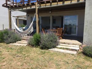 a porch with a hammock on a house at La Toscana 1 in Piriápolis