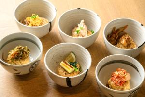 a group of four bowls of food on a table at Hotel Forza Oita in Oita