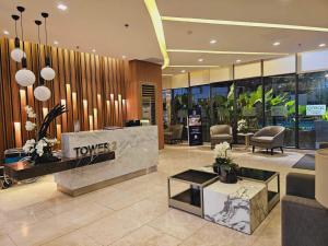 a lobby with a hotel reception desk and chairs at SM Spring Residences Tower 2 Condominium Bicutan Parañaque Cozy Condo in Manila