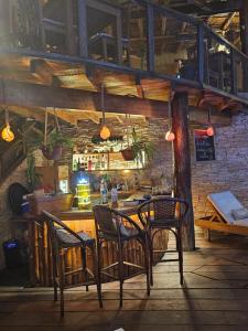 a restaurant with two chairs and a table and a bar at Los Corales in Máncora