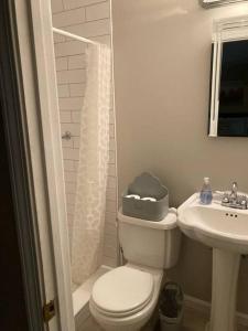 a small bathroom with a toilet and a sink at Quiet Kennesaw 3BR home - close to KSU, Lakepoint in Kennesaw