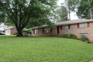 a brick house with a tree in the yard at Quiet Kennesaw 3BR home - close to KSU, Lakepoint in Kennesaw