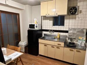 uma cozinha com um lavatório e um micro-ondas em Nishimoto Building - Vacation STAY 16015v em Hiroshima