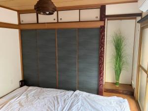 a bedroom with a bed with a metal headboard at Nishimoto Building - Vacation STAY 93789v in Hiroshima