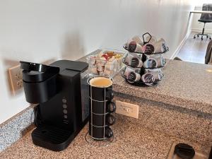 a coffee maker on a counter with a tray of dishes at Stylish Downtown High-Rise - 2BD in Baton Rouge