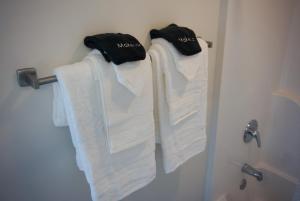 a group of towels hanging on a rack in a bathroom at Stylish Downtown High-Rise - 2BD in Baton Rouge