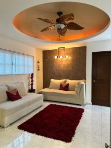 een woonkamer met 2 witte banken en een plafond bij Casa Sasha's Mini Palace in Cancun