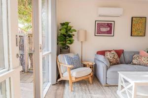a living room with a couch and a chair at Cosy Corner Hideaway in Torquay