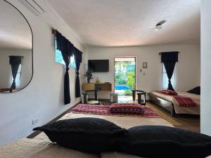 a bedroom with two beds and a mirror at Hotel Atelie del Mar in Monterrico