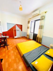 a bedroom with a large yellow bed in a room at Lion HOMESTAY in Ninh Binh