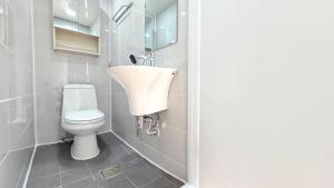 a bathroom with a sink and a toilet at Someday Jeju in Jeju +27 photos