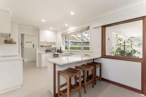 a kitchen with a white counter and a window at Fisherman's Rest in Emu Point