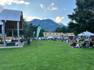 a group of people sitting on the grass in a park at August Jack Motor Inn in Squamish