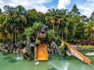 a slide in the water at a theme park at Adiniz@HotSpring Sg Klah in Sungkai