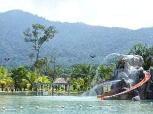 a water park with a water slide in the water at Adiniz@HotSpring Sg Klah in Sungkai