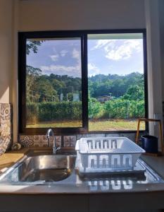 a kitchen counter with a sink and a window at Casa Farolito in Hone Creek
