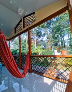 a hammock on a screened in porch with a view at Casa Farolito in Hone Creek