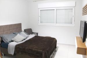 Postel nebo postele na pokoji v ubytování Quarto em Estância Velha