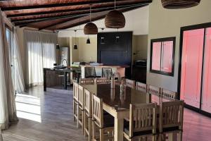 a kitchen with a large wooden table and chairs at Hermosa casa en Cafayate in Cafayate
