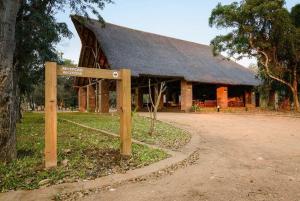 a wooden building with a sign in front of it at Montebelo Gorongosa Lodge & Safari in Chitengo