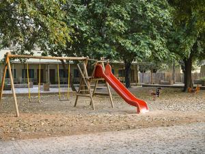 a playground with a red slide in a park at Montebelo Gorongosa Lodge & Safari in Chitengo