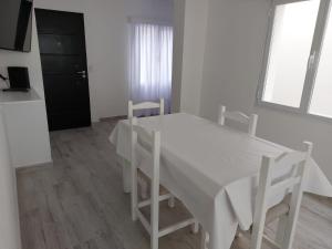 a white table and chairs in a white room at Don Quijote Tandil in Tandil