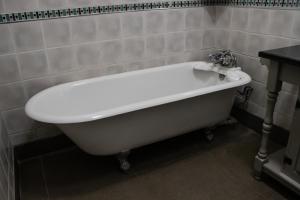 a white bath tub sitting in a bathroom at Siesta Guesthouse & Wedding Venue - Frankfort in Frankfort