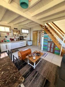 a living room with a table and a kitchen at Martera in Constitución