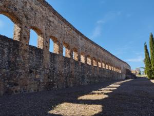 an old brick wall with arches on the side at Los Álamos in Mérida