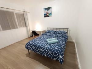 a bedroom with a bed with two pillows on it at PROMO! Entire 2 Bedroom Unit Near Train Station! Free Parking & Wifi! in Melbourne