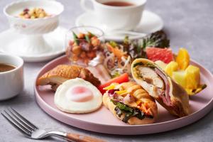 a pink plate of food on a table at Art Hotel Osaka Bay Tower in Osaka