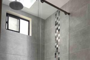 La salle de bains est pourvue d'une douche et d'une fenêtre. dans l'établissement Cómodo apto, excelente ubicación Sabaneta, à Sabaneta