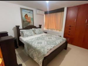 a bedroom with a bed and a dresser and a window at RH06 Riohacha apto con vista mar 7 piso 4 personas in Ríohacha