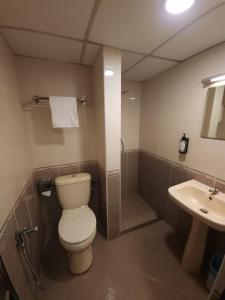 a bathroom with a toilet and a sink at Go Lodge Hotel Kuantan in Kuantan