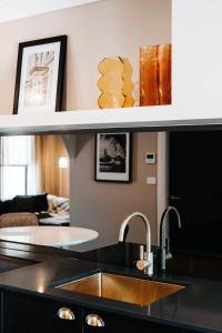 a kitchen with a sink and a living room at McKenna Terraces in Mudgee