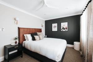 1 dormitorio con cama y pared negra en McKenna Terraces en Mudgee