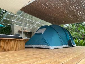 a blue tent sitting on top of a wooden floor at Serenity Glamping in Puerto Viejo