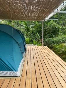 a blue tent sitting on a wooden deck at Serenity Glamping in Puerto Viejo