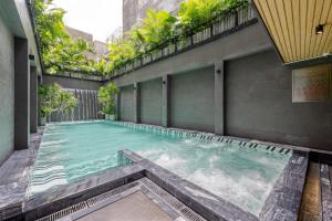 a swimming pool in the middle of a building at La Siesta Classic Hang Thung in Hanoi