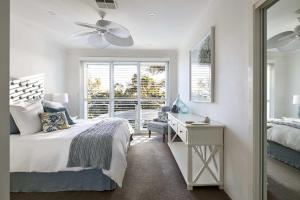 a bedroom with a bed and a desk and a window at Arabella in Nelson Bay