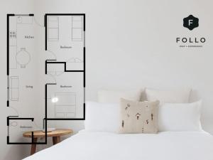 a bedroom with a large white bed with at No 3 ShoalHaven - 1 bed option in Shoal Bay