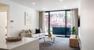 a living room with a couch and a table at The Muse in Newcastle